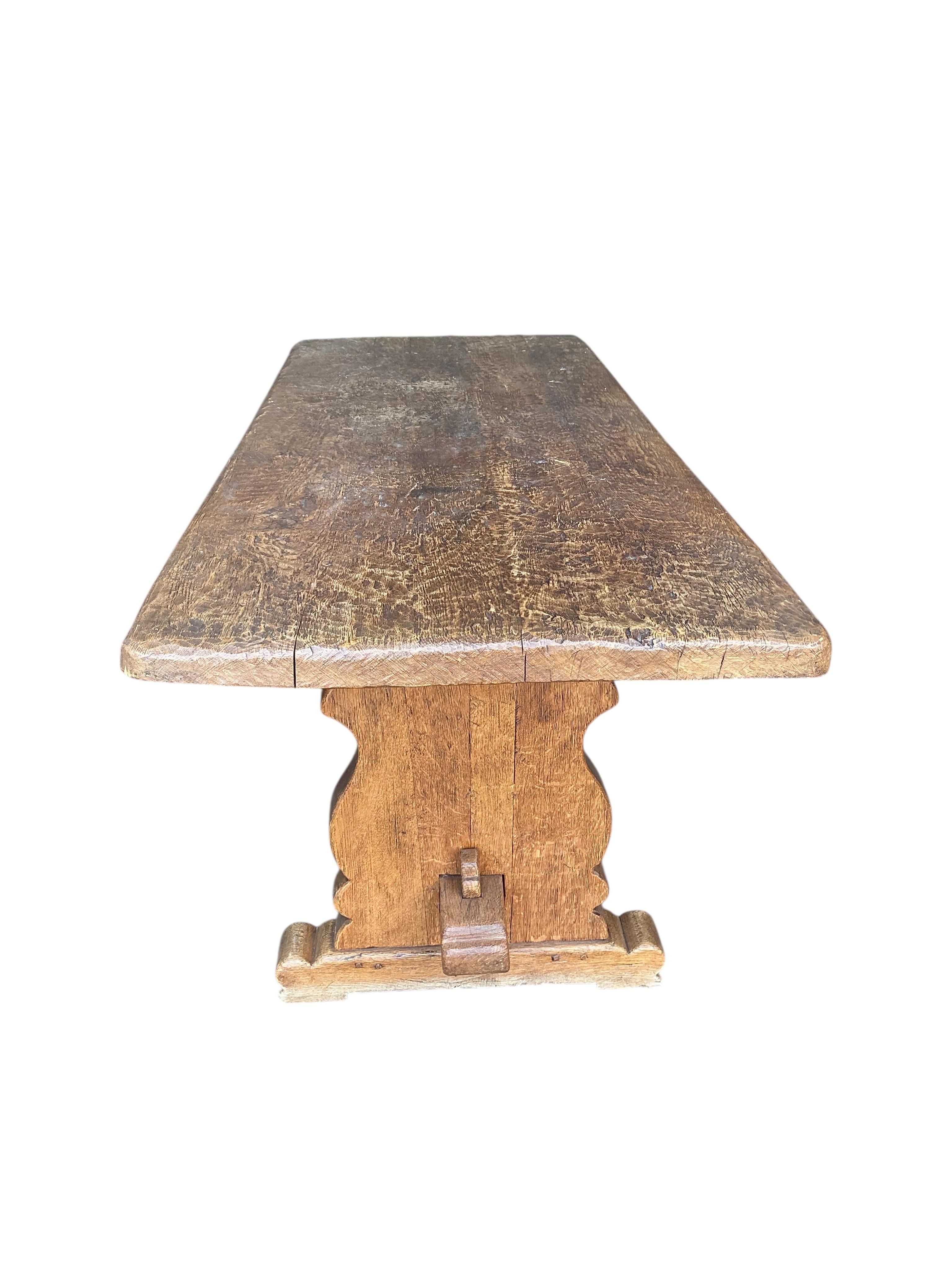 An 18th century style rectangular oak refectory table with adzed single plank top, width 198cm, depth 78cm, height 72cm